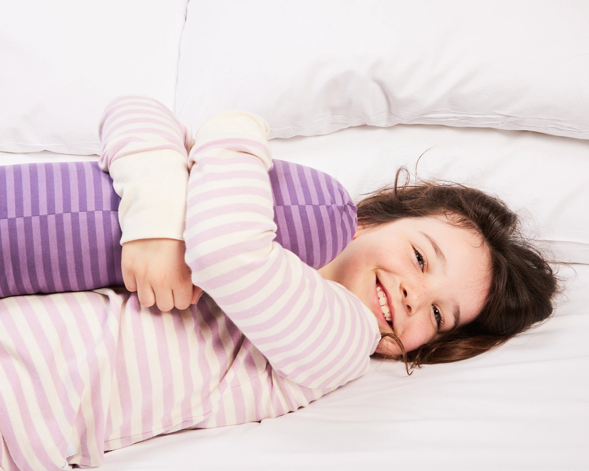 Young girl enjoys sleeping with her purple short sleeper