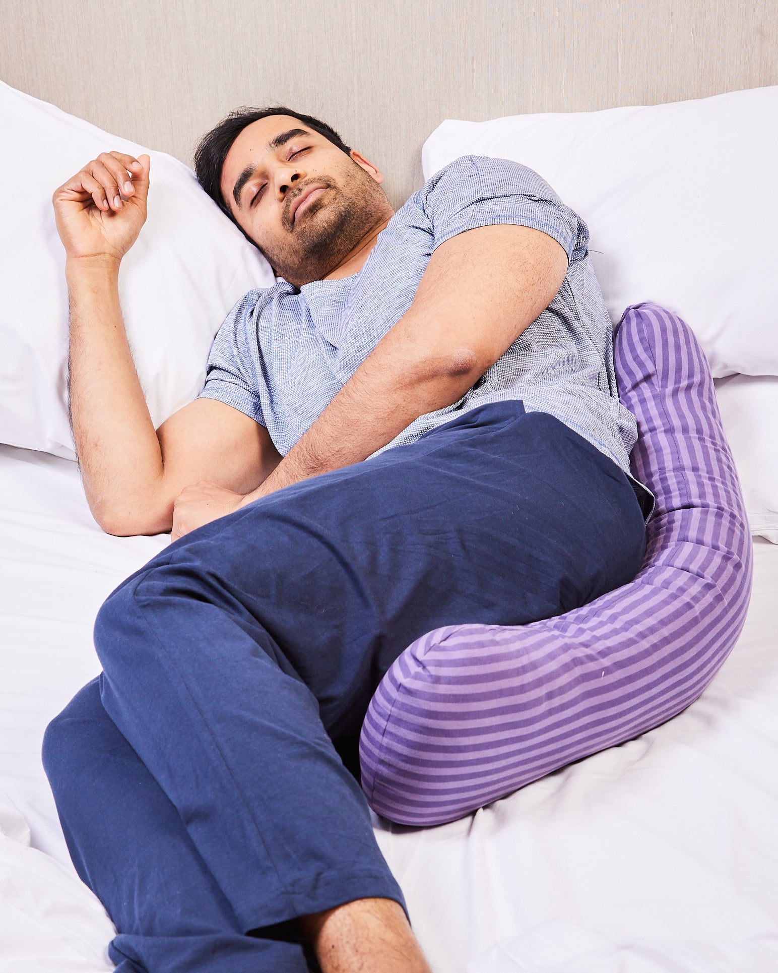Male using weighted pillow to sleep better
