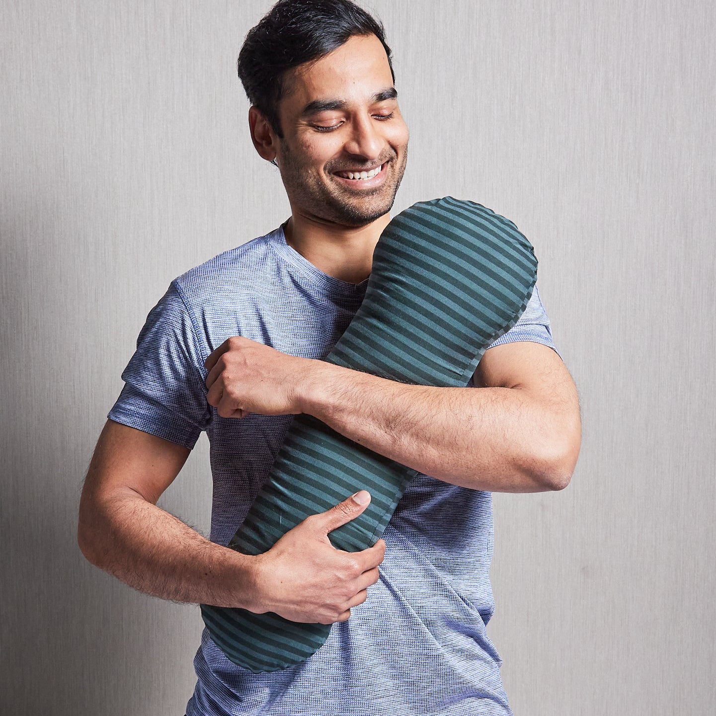 Adult male hugging his weighted short pillow